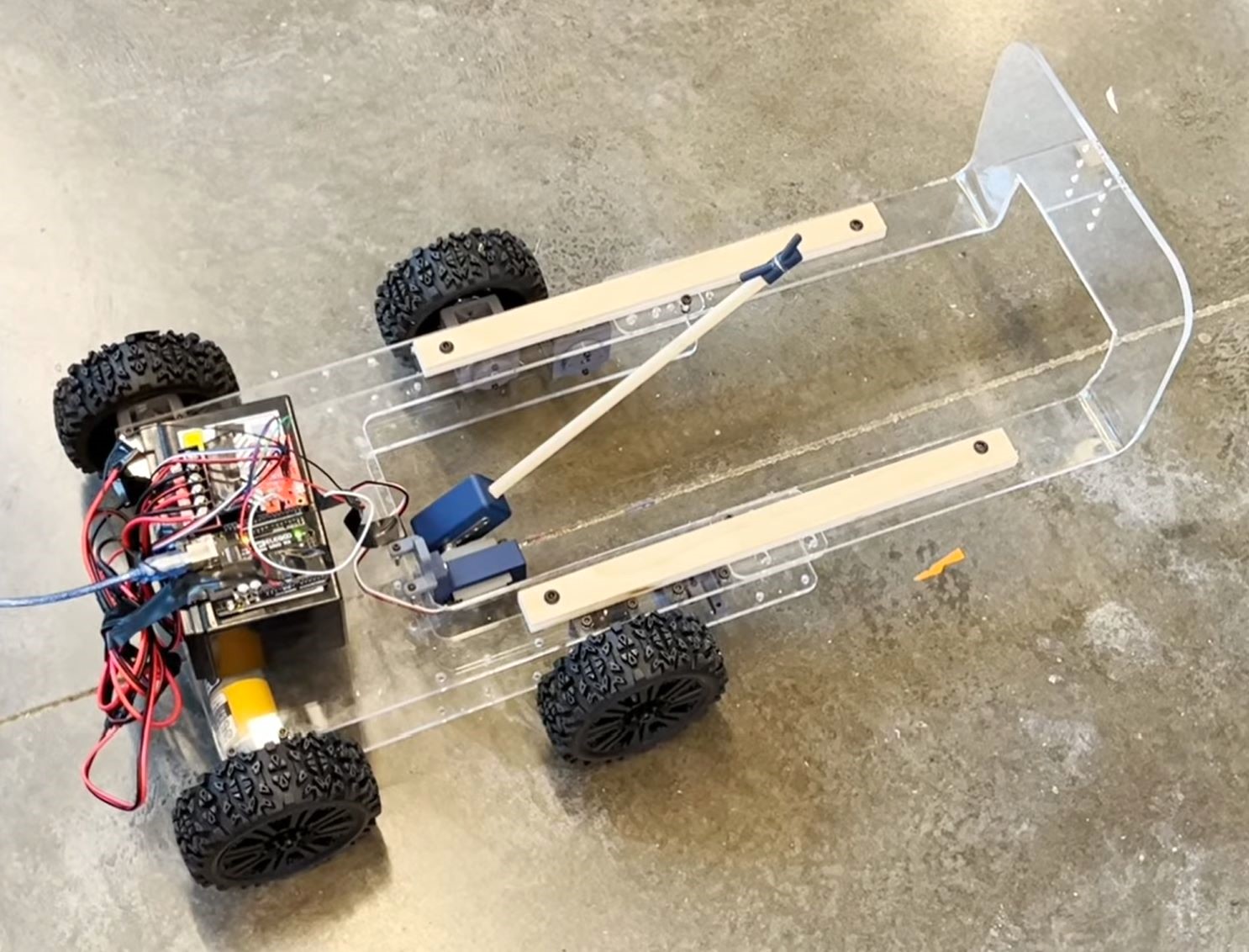 First prototype of robot. Full-system concept was drafted using SolidWorks, and prototype was built using 3D printed, laser cut, and off-the shelf components. Building the robot was a team effort.