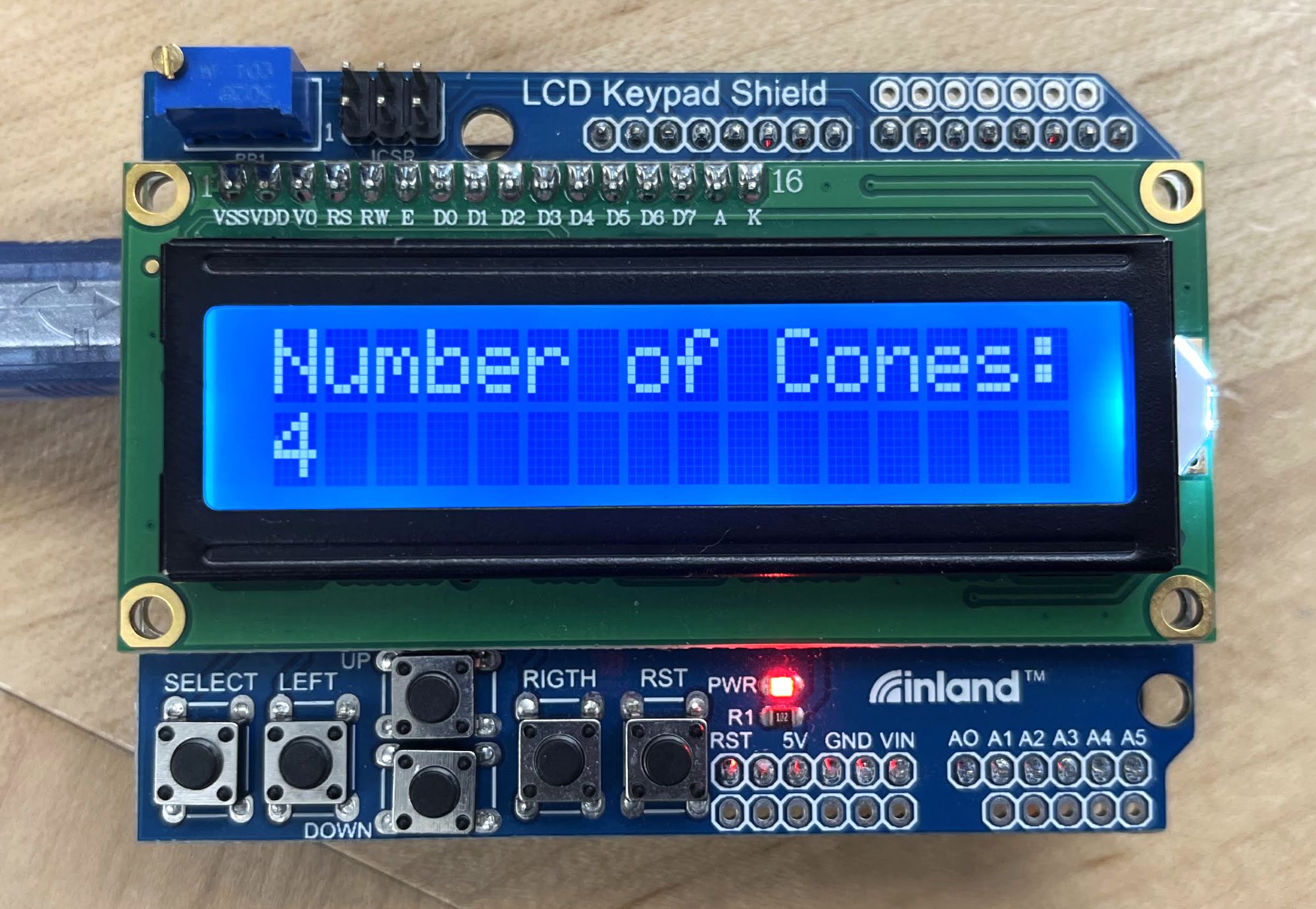 User interface, programmed for Arduino. Buttons below screen were used for input. Inputs included number of cones for the robot to pick up, terrain, and size of collection area.