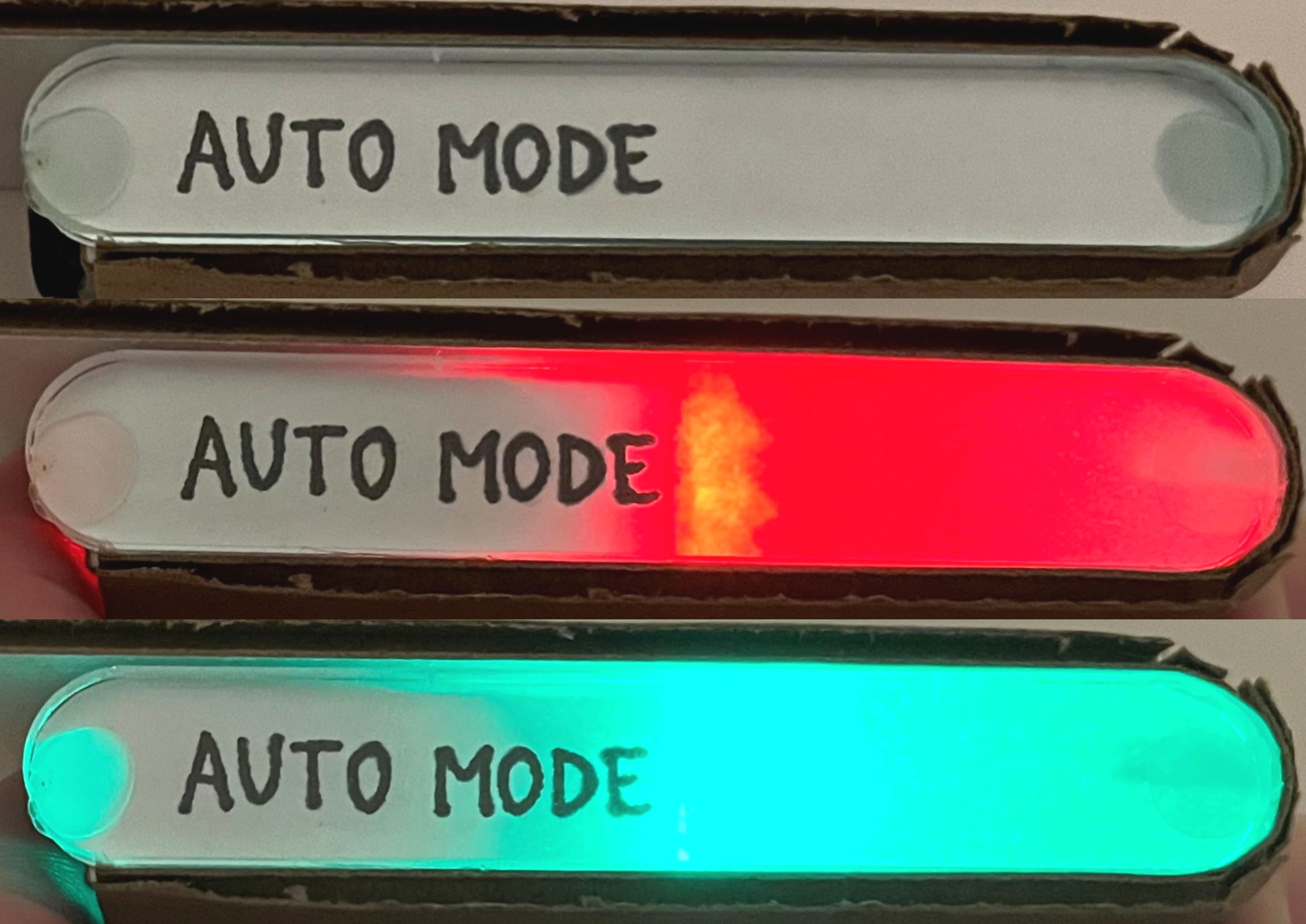 Physical button to toggle automatic driving mode, used in final prototype. Constructed and soldered by me using a common anode LED, a switch, button cell batteries, and acrylic. Light indicates whether auto mode is (from top) unavailable, off, or on.